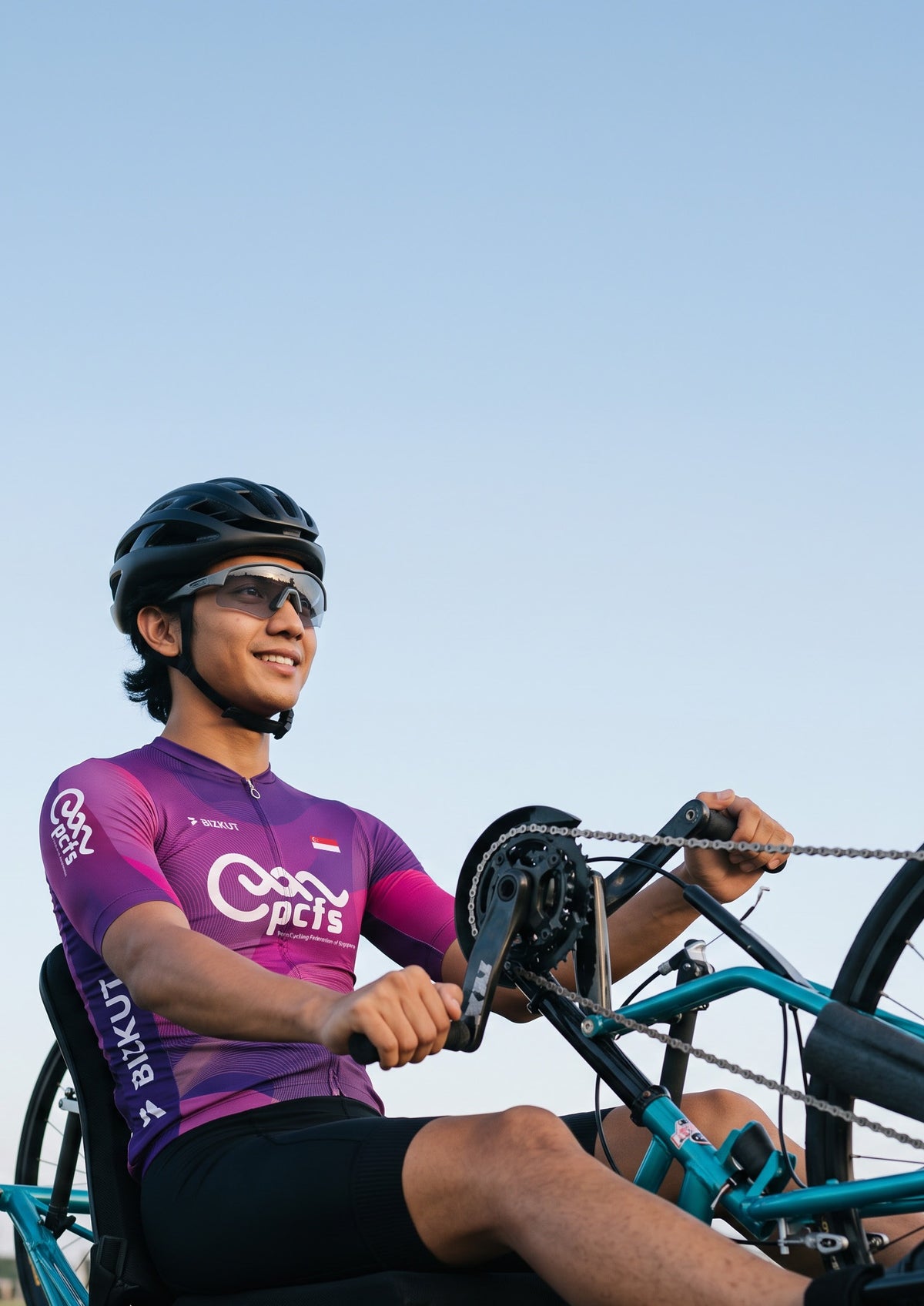 Two cyclists wearing purple custom jerseys and bibshorts